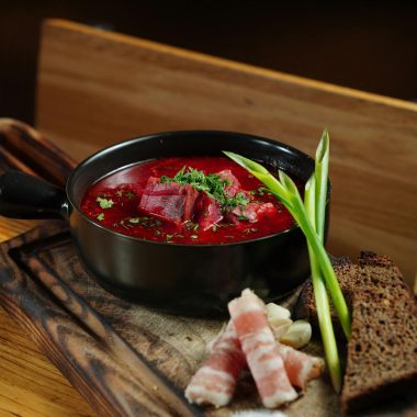 ### **The Cultural Significance of Borscht:** Borscht is more than just a meal; it’s a cultural symbol deeply rooted in the traditions of Ukraine and other Eastern European countries. Passed down through generations, this humble yet flavorful soup has become a national dish, often enjoyed during family gatherings, festive occasions, or even as a comforting daily staple. Each family has its own version, with recipes varying slightly by region and personal preference—some prefer a more sour version with extra vinegar, while others add more sweetness with a hint of sugar. Despite its many variations, borscht remains a dish that brings people together around the table, embodying warmth and hospitality. In addition to its cultural importance, borscht has also gained international recognition due to its versatility and health benefits. As more people seek nutrient-dense, plant-based meals, this vibrant beet soup has found a place in kitchens worldwide. Whether served hot or cold, as a starter or a main course, borscht’s blend of simple ingredients delivers a satisfying and nourishing meal for any occasion. --- ### **Borscht as Part of a Balanced Diet:** Incorporating borscht into your diet is an easy way to boost your intake of essential vitamins and minerals. The beets, a primary ingredient, are known for their ability to improve blood circulation and reduce inflammation due to their high levels of nitrates and antioxidants. The soup is naturally low in calories but rich in fiber, which aids digestion and promotes satiety. For those looking to maintain or lose weight, borscht offers a low-calorie, filling meal option that keeps you full without compromising on flavor. Whether you're looking to try a new recipe, embrace traditional Eastern European cuisine, or simply eat healthier, borscht is a delicious and nutritious choice that deserves a spot in your regular meal rotation. --- ### **Updated Tags:** borscht recipe, beet soup, traditional Ukrainian soup, healthy soup, vegetarian borscht, comfort food, Eastern European recipes, winter soups, beetroot recipe, vegan borscht, meat borscht, cultural recipes, low-calorie soups, antioxidant-rich foods, fiber-rich meals, traditional cuisine recipes