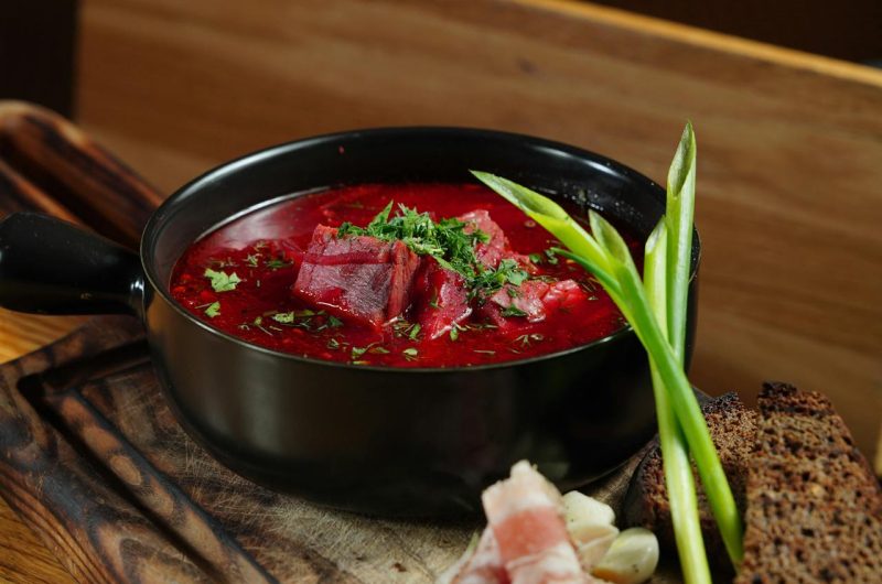 ### **The Cultural Significance of Borscht:** Borscht is more than just a meal; it’s a cultural symbol deeply rooted in the traditions of Ukraine and other Eastern European countries. Passed down through generations, this humble yet flavorful soup has become a national dish, often enjoyed during family gatherings, festive occasions, or even as a comforting daily staple. Each family has its own version, with recipes varying slightly by region and personal preference—some prefer a more sour version with extra vinegar, while others add more sweetness with a hint of sugar. Despite its many variations, borscht remains a dish that brings people together around the table, embodying warmth and hospitality. In addition to its cultural importance, borscht has also gained international recognition due to its versatility and health benefits. As more people seek nutrient-dense, plant-based meals, this vibrant beet soup has found a place in kitchens worldwide. Whether served hot or cold, as a starter or a main course, borscht’s blend of simple ingredients delivers a satisfying and nourishing meal for any occasion. --- ### **Borscht as Part of a Balanced Diet:** Incorporating borscht into your diet is an easy way to boost your intake of essential vitamins and minerals. The beets, a primary ingredient, are known for their ability to improve blood circulation and reduce inflammation due to their high levels of nitrates and antioxidants. The soup is naturally low in calories but rich in fiber, which aids digestion and promotes satiety. For those looking to maintain or lose weight, borscht offers a low-calorie, filling meal option that keeps you full without compromising on flavor. Whether you're looking to try a new recipe, embrace traditional Eastern European cuisine, or simply eat healthier, borscht is a delicious and nutritious choice that deserves a spot in your regular meal rotation. --- ### **Updated Tags:** borscht recipe, beet soup, traditional Ukrainian soup, healthy soup, vegetarian borscht, comfort food, Eastern European recipes, winter soups, beetroot recipe, vegan borscht, meat borscht, cultural recipes, low-calorie soups, antioxidant-rich foods, fiber-rich meals, traditional cuisine recipes